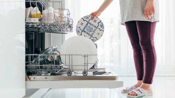 Pessoa a selecionar programa de lavagem de loiça